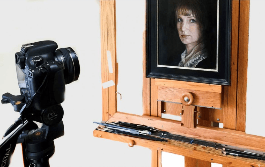 A camera and a frame with a woman’s picture